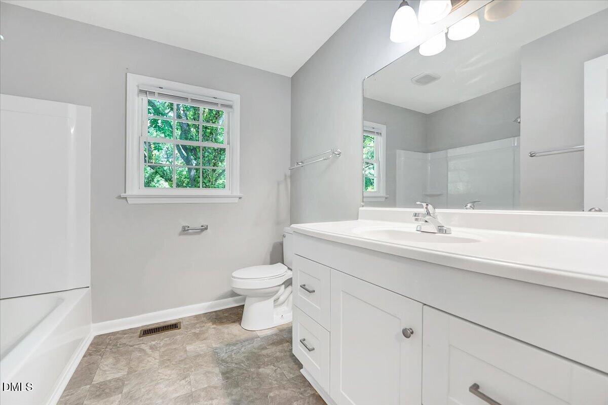 3408 Atlantic Avenue Raleigh, NC 27604 - Photo 38 of 48 a bathroom with a sink a toilet and a mirror