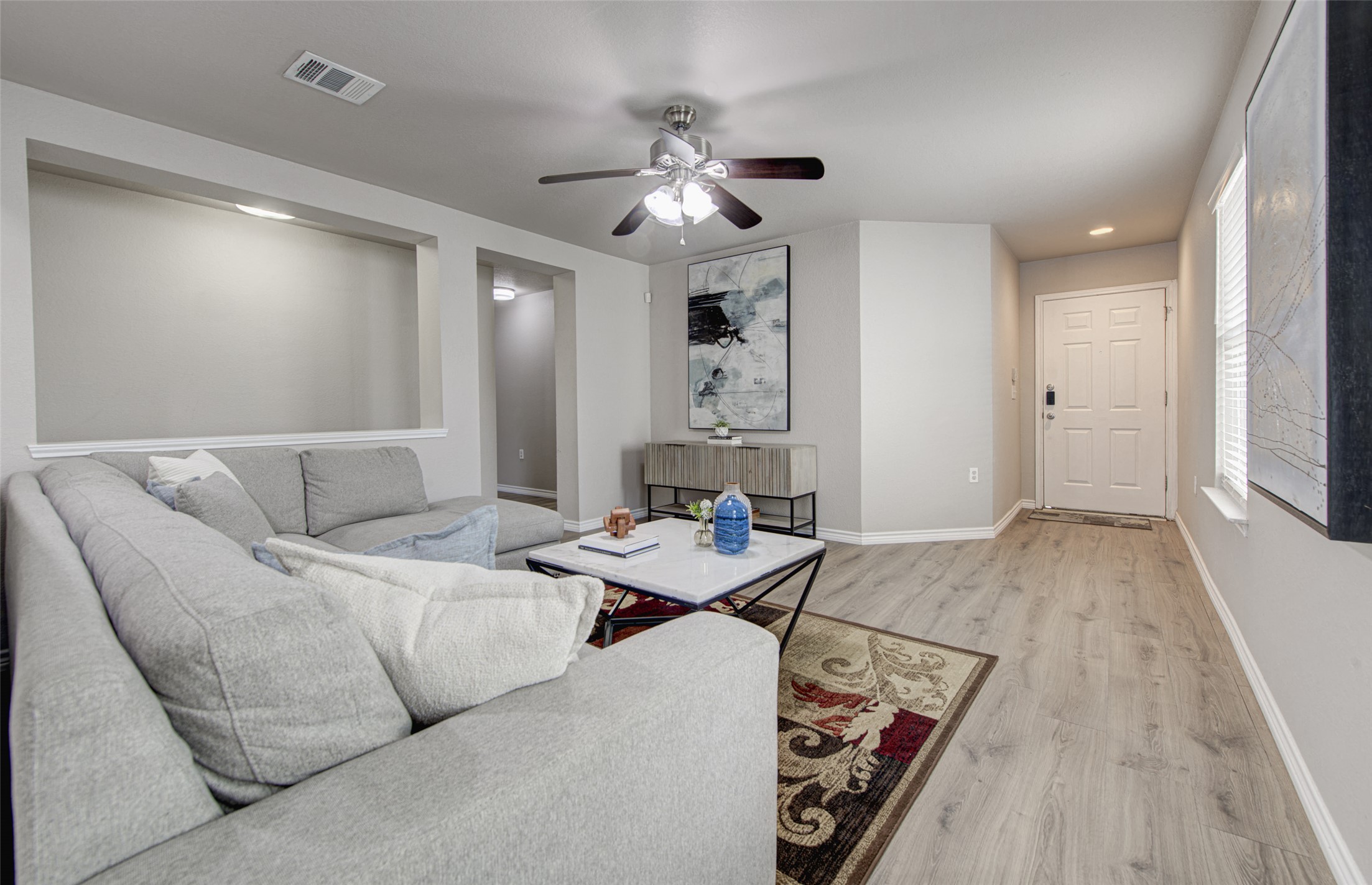 6709 Doyal Drive Austin, TX 78747 - Photo 6 of 22 Living room featuring light wood-style flooring, ceiling fan, and recessed lighting