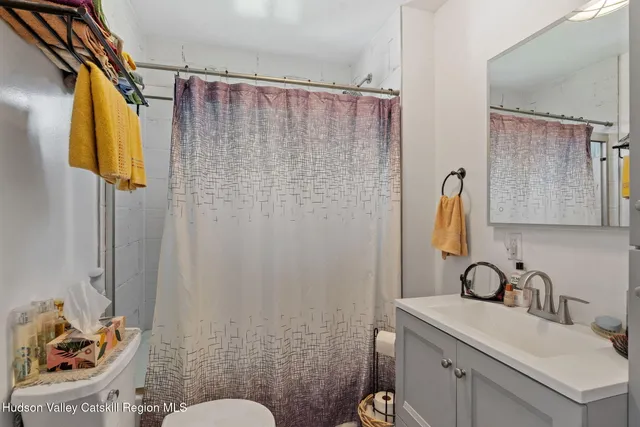 a bathroom with a sink a toilet and shower curtain