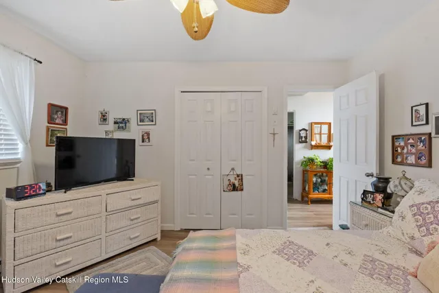 a bedroom with a bed and flat screen tv