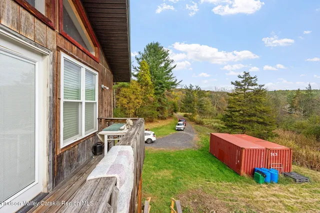 a view of a chairs and table on the wooden deck