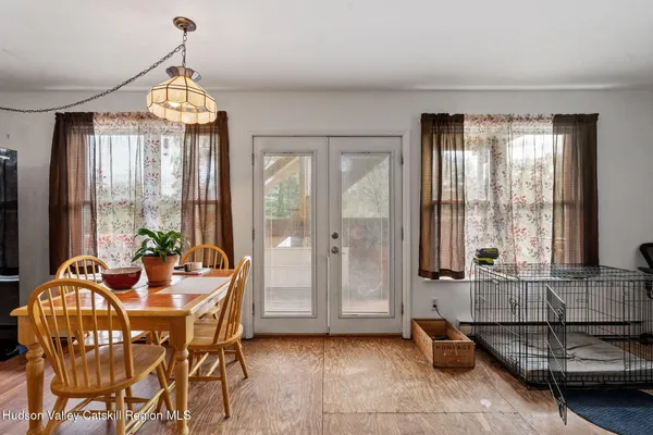 a view of a dining room with furniture and windows