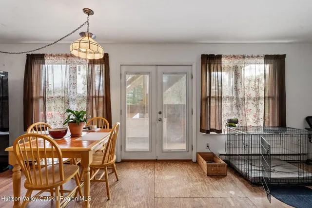 a view of a dining room with furniture and windows