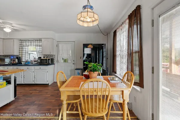 a view of a dining room with furniture window and wooden floor