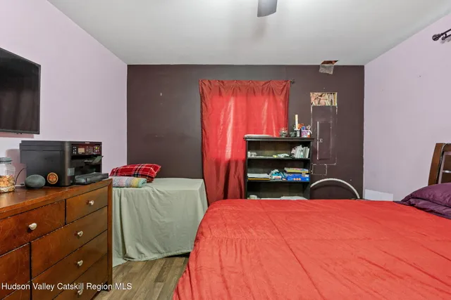 a bedroom with a bed and a tv in it