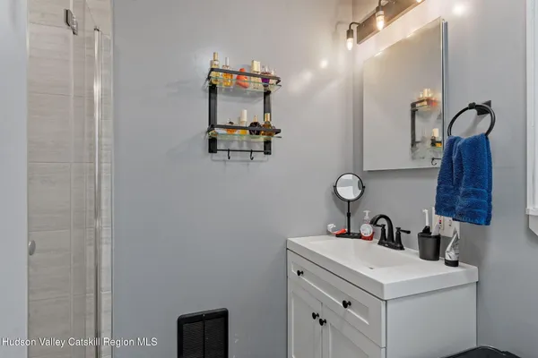 a bathroom with a sink vanity and mirror