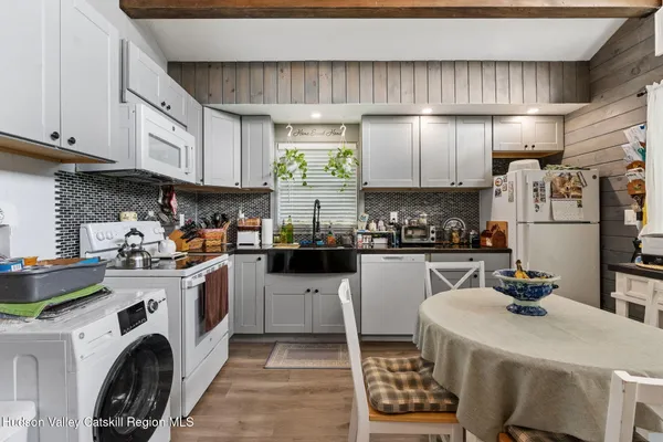 a kitchen with a sink a refrigerator and cabinets