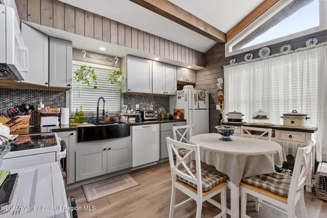 a kitchen with stainless steel appliances a stove a sink a refrigerator and cabinets