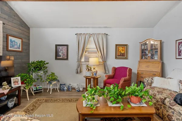 a room with furniture a rug and a window