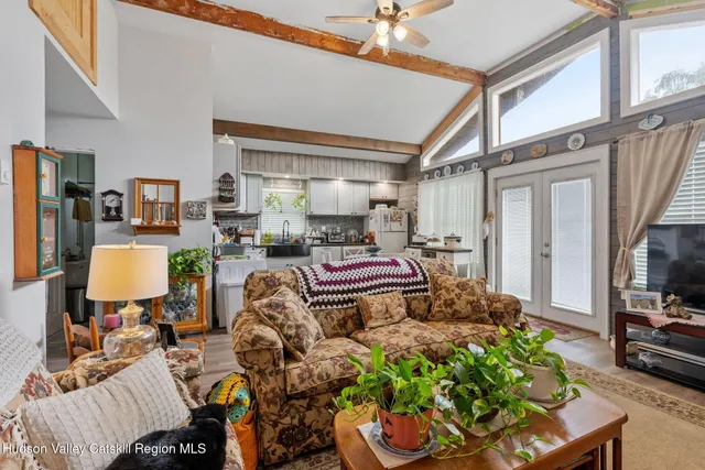a living room filled with furniture and a flat screen tv