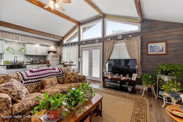 a living room with furniture a fireplace and a flat screen tv