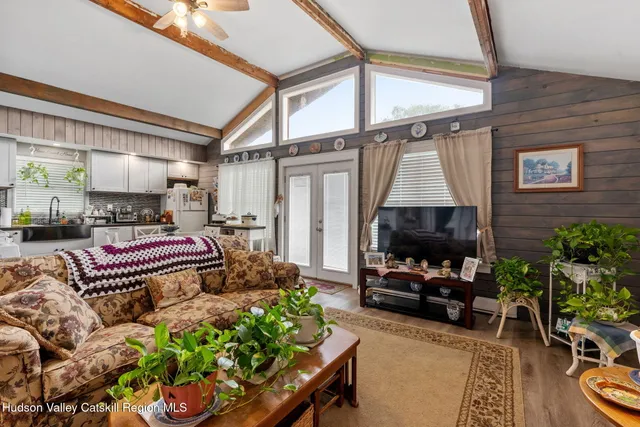 a living room with furniture a fireplace and a flat screen tv