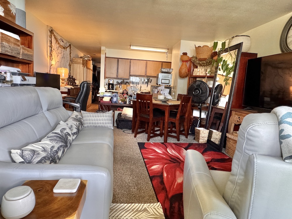 320 Papaloa Road, Unit 102 Kapaa, HI 96746 - Photo 10 of 22 a living room with furniture a flat screen tv and a view of kitchen