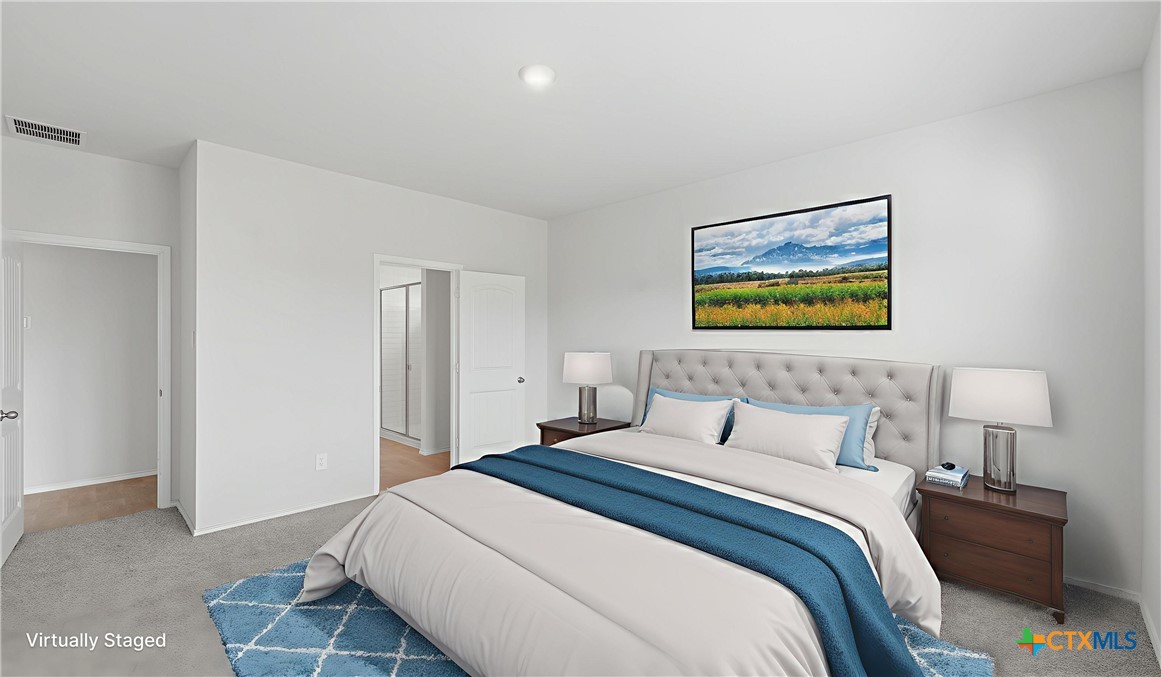 1708 Violeteared Way Lockhart, TX 78644 - Photo 12 of 25 a bedroom with a bed and a painting on the wall