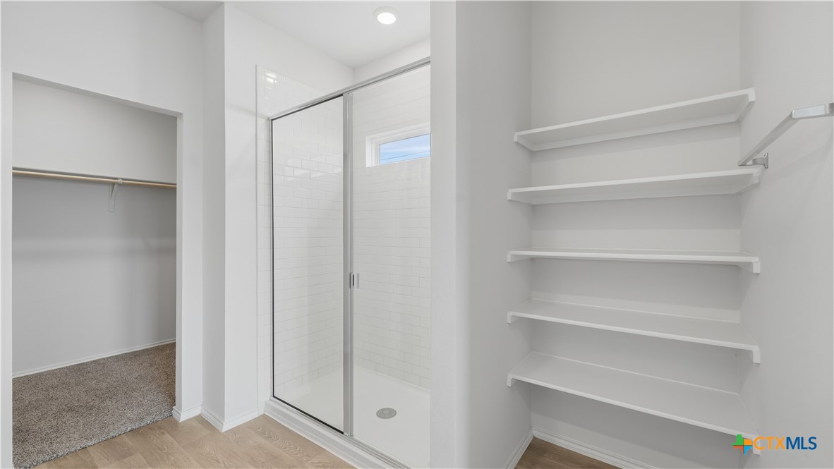 1708 Violeteared Way Lockhart, TX 78644 - Photo 16 of 25 a view of walk in closet with empty racks