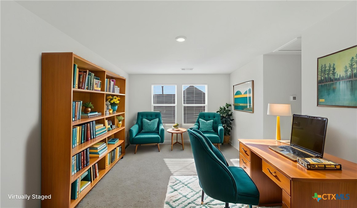 1708 Violeteared Way Lockhart, TX 78644 - Photo 17 of 25 a living room with a large window and a book shelf