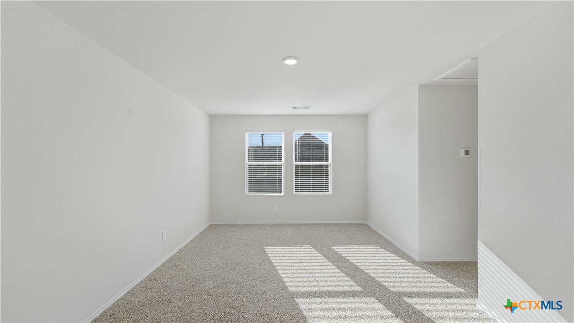 1708 Violeteared Way Lockhart, TX 78644 - Photo 18 of 25 a view of an empty room with a window