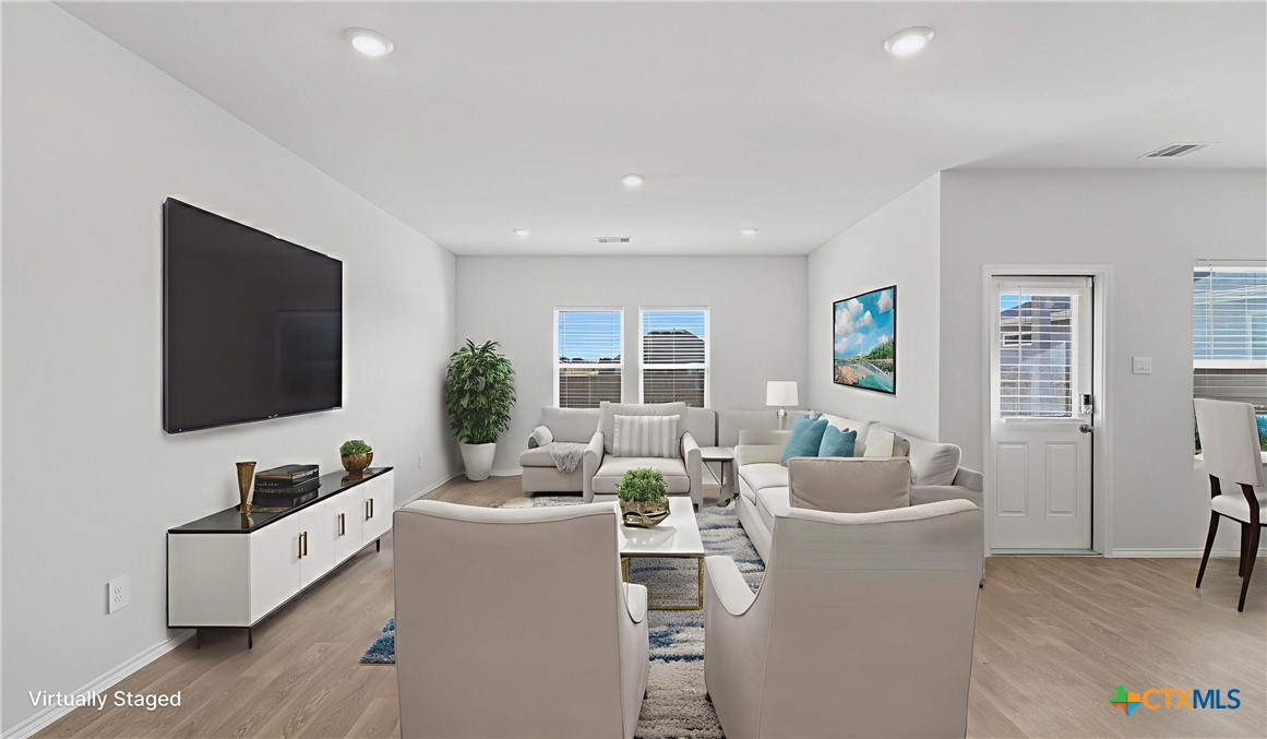 1708 Violeteared Way Lockhart, TX 78644 - Photo 3 of 25 a living room with furniture and a flat screen tv