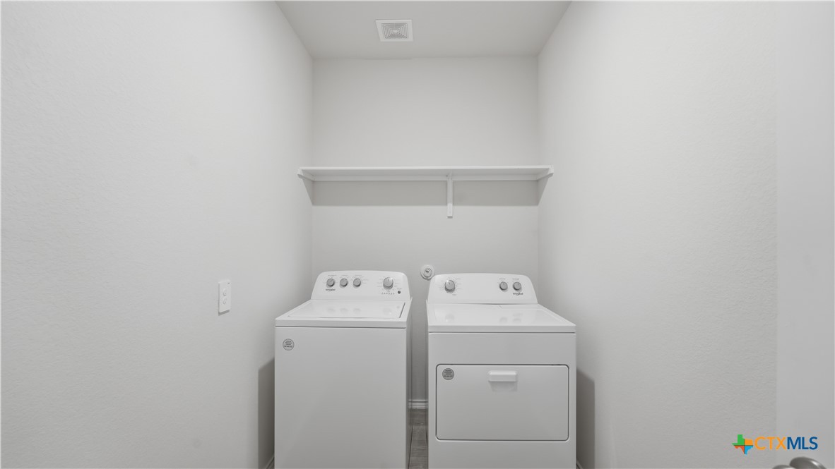 1708 Violeteared Way Lockhart, TX 78644 - Photo 8 of 25 a utility room with dryer and washer