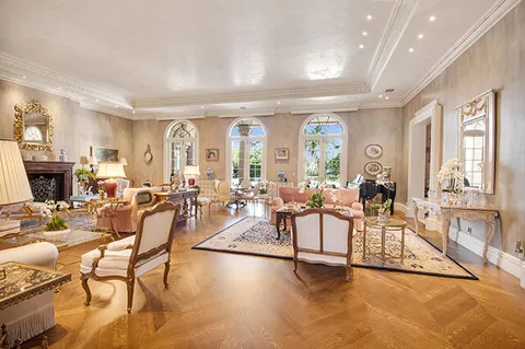 a living room with furniture and floor to ceiling windows