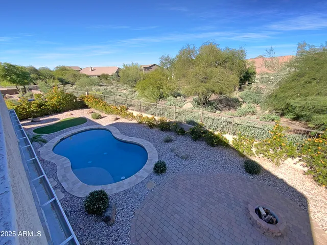 a view of a swimming pool with a yard