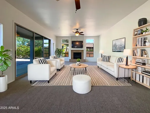 a living room with furniture fireplace and flat screen tv