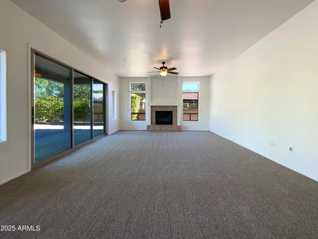 a view of a livingroom with an empty space and a fireplace