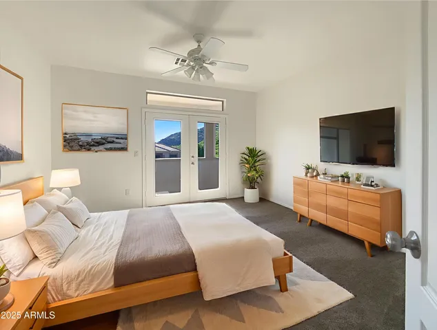 a bedroom with a bed and a flat screen tv