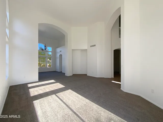 a view of a hallway with wooden floor and a bathroom