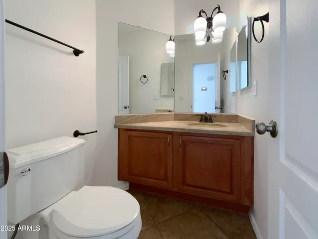 a bathroom with a sink a toilet and mirror