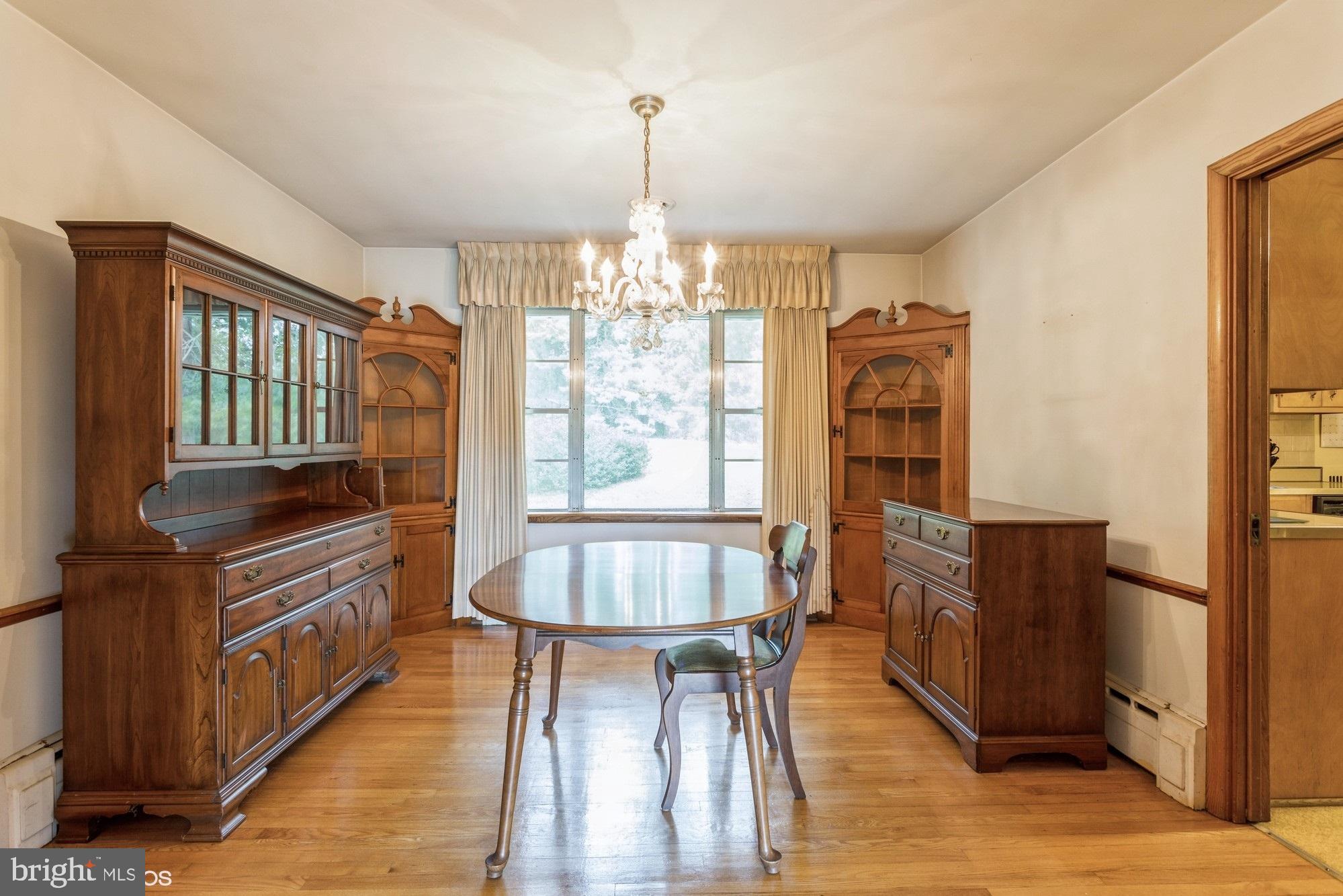 505 Whitaker Mill Road Fallston, MD 21047 - Photo 16 of 49 a dining room with furniture a chandelier and wooden floor