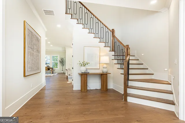 a view of entryway and hall with wooden floor