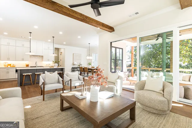a living room with fireplace furniture and a large window