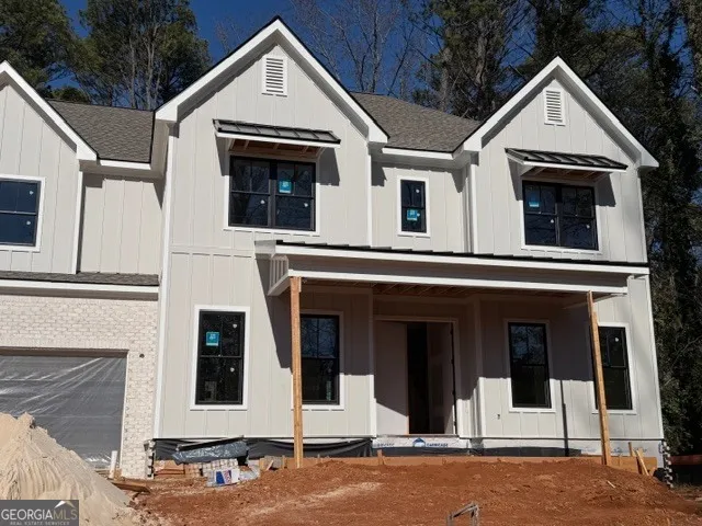 a view of a white house with large windows