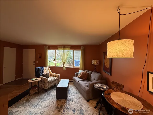 a living room with furniture a lamp and a table