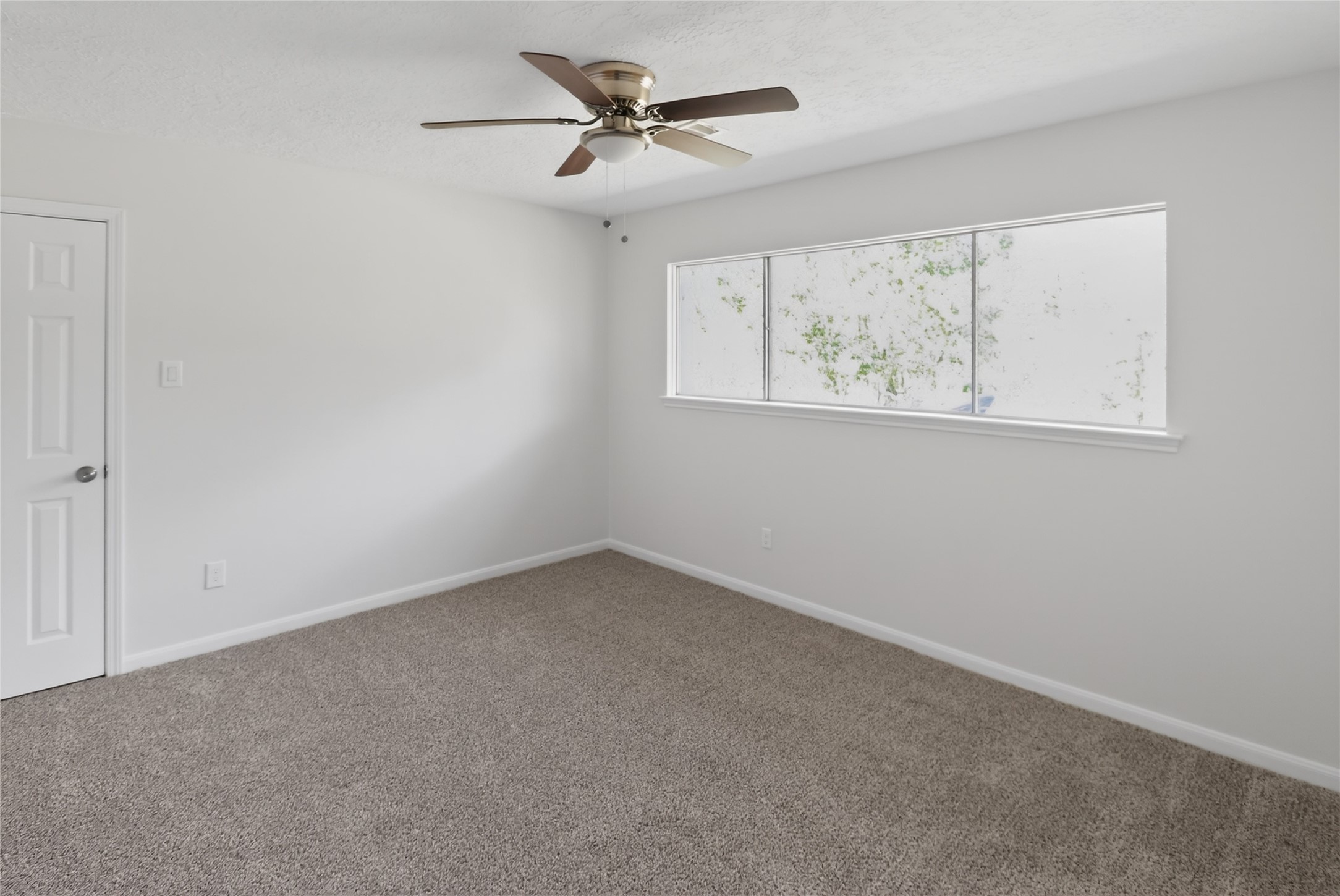 133 Cherry Tree Lane Friendswood, TX 77546 - Photo 16 of 27 an empty room with windows and a chandelier fan