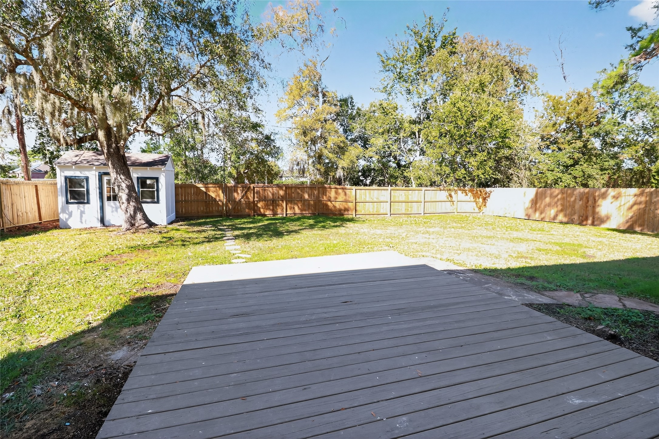 133 Cherry Tree Lane Friendswood, TX 77546 - Photo 22 of 27 a view of a swimming pool with a yard and large trees