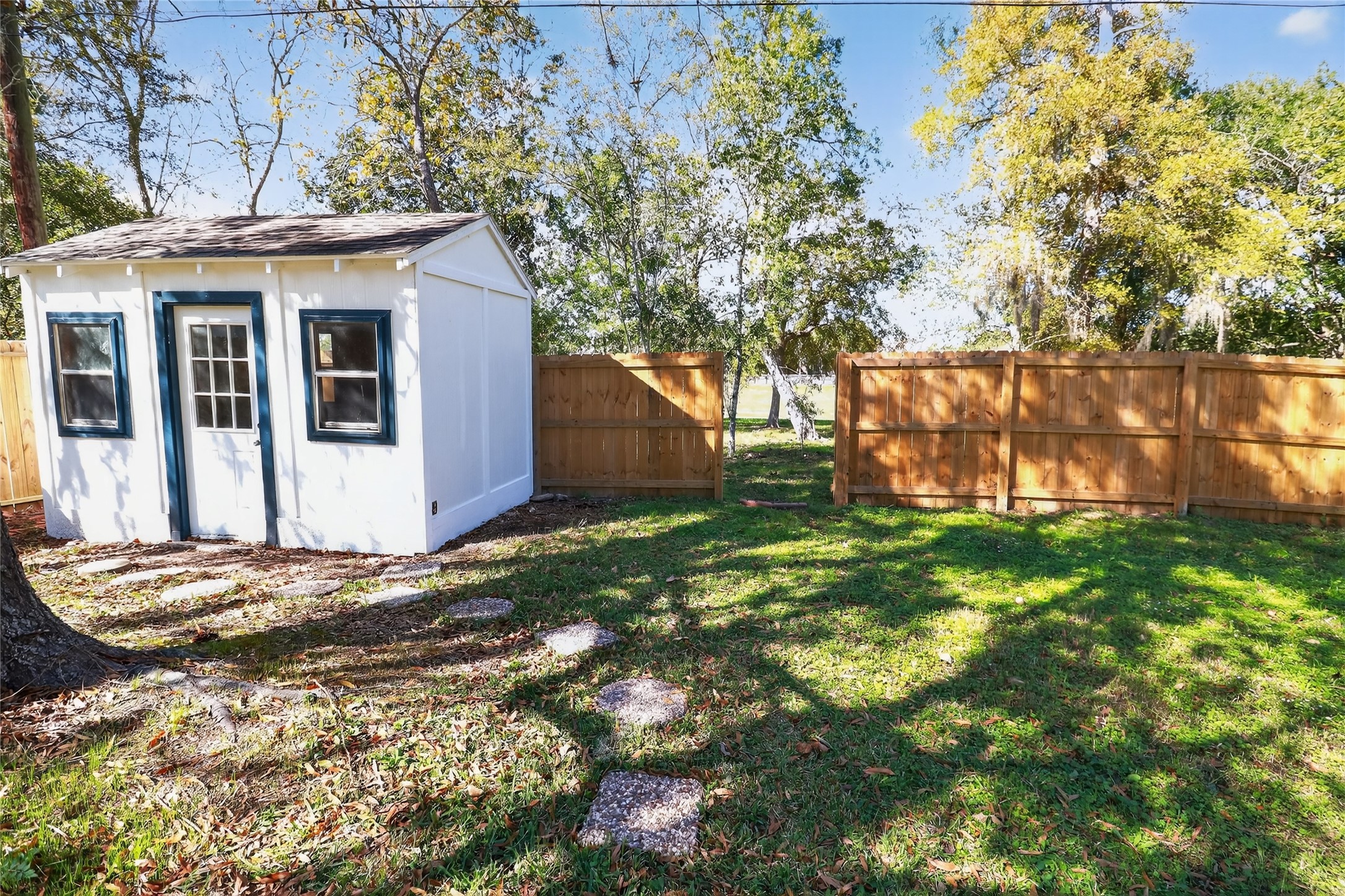 133 Cherry Tree Lane Friendswood, TX 77546 - Photo 23 of 27 a view of a house with a backyard