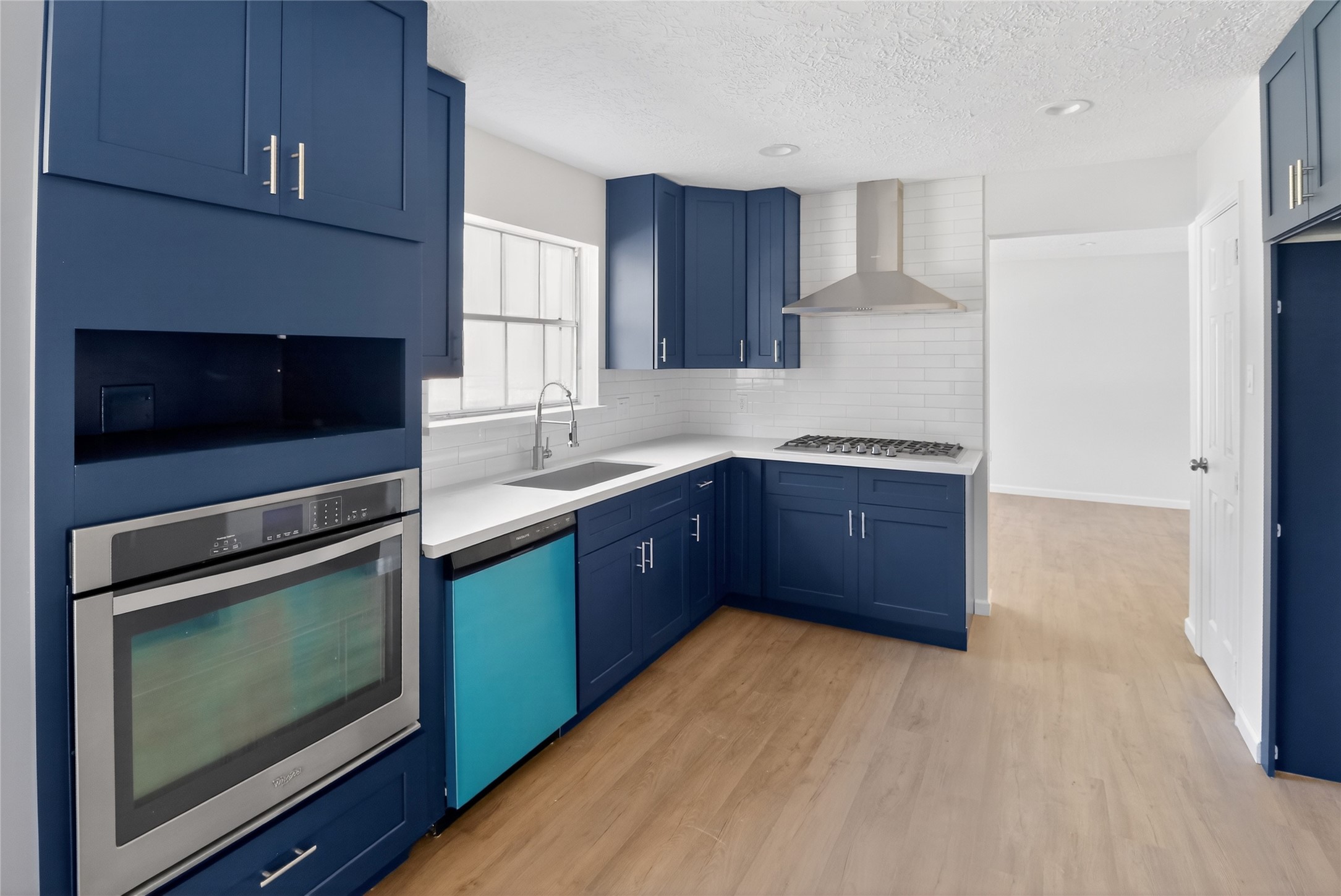 133 Cherry Tree Lane Friendswood, TX 77546 - Photo 6 of 27 a kitchen with stainless steel appliances granite countertop a stove a microwave and a sink