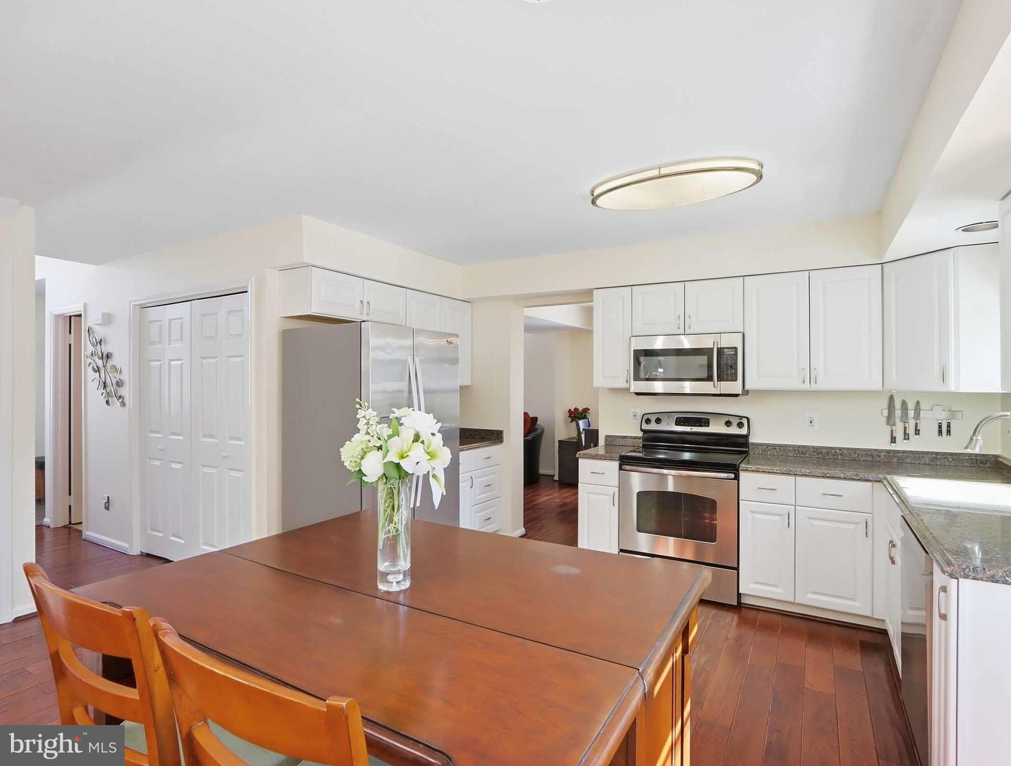 12208 Stoney Bottom Road Germantown, MD 20874 - Photo 12 of 52 a kitchen with stainless steel appliances granite countertop a refrigerator a stove top oven a sink and dishwasher