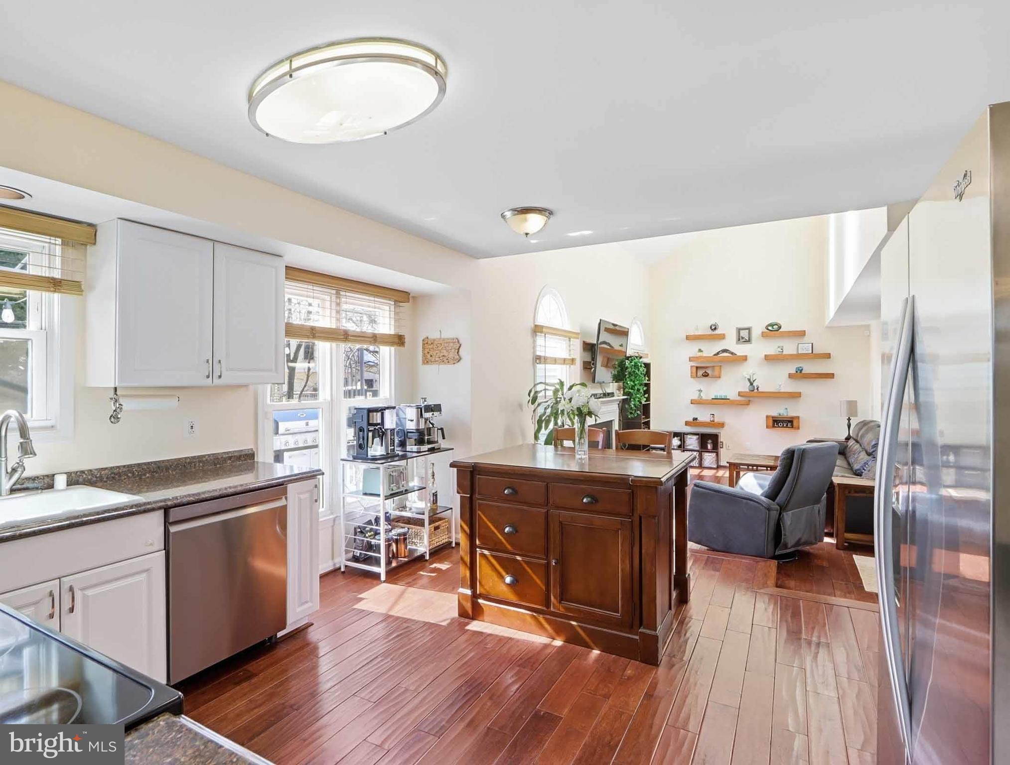 12208 Stoney Bottom Road Germantown, MD 20874 - Photo 13 of 52 a view of a kitchen and dining room with wooden floor