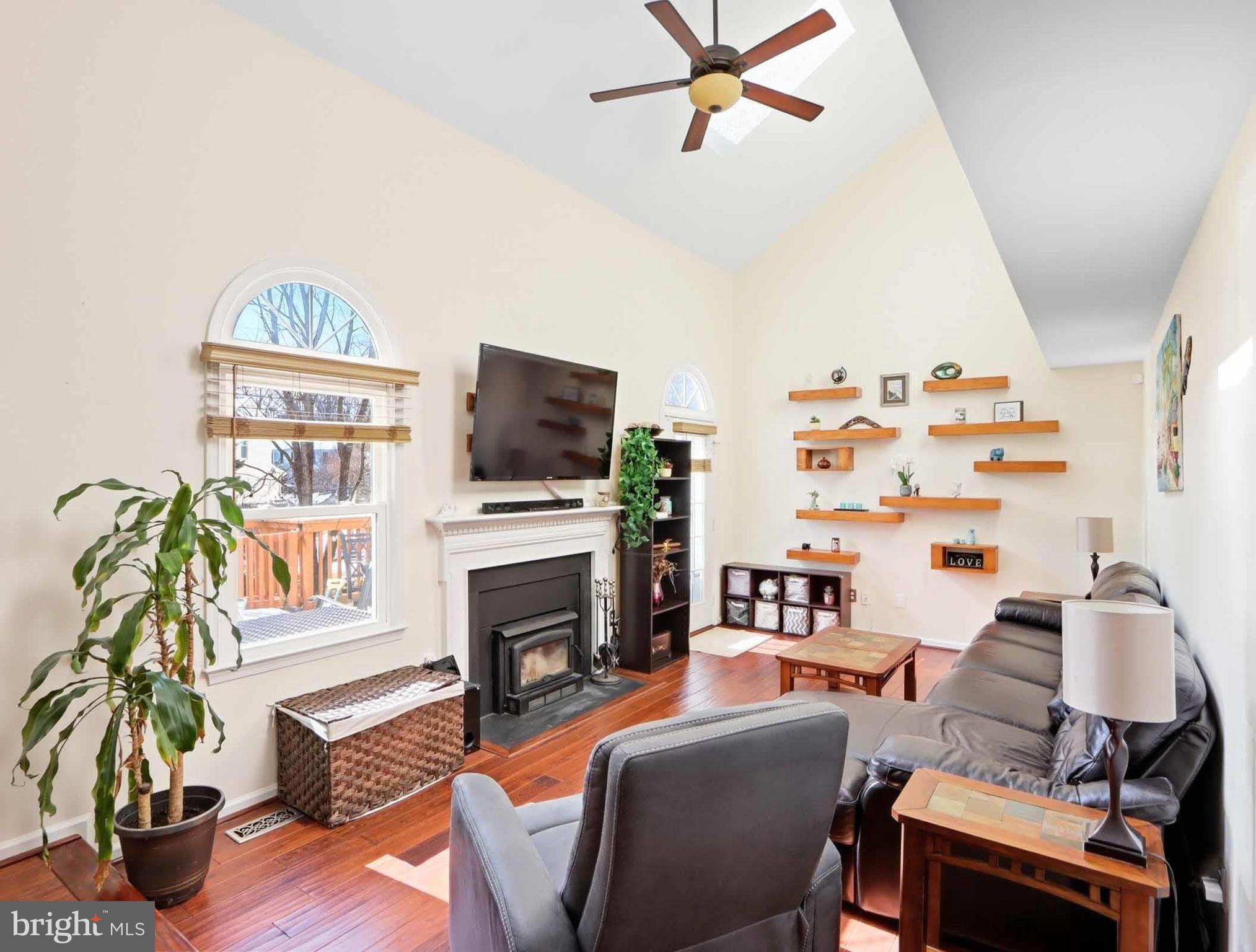 12208 Stoney Bottom Road Germantown, MD 20874 - Photo 16 of 52 a living room with furniture a flat screen tv and a fireplace