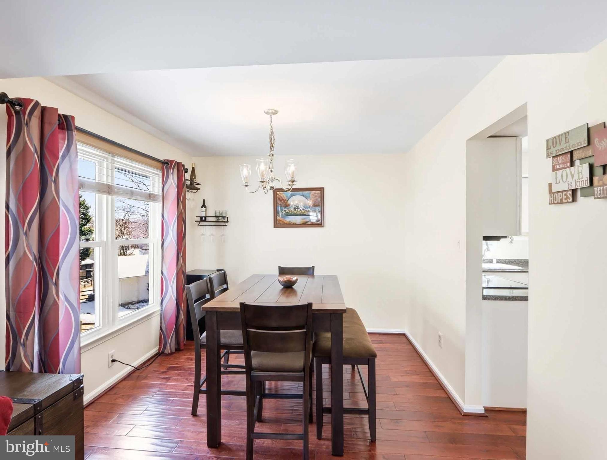 12208 Stoney Bottom Road Germantown, MD 20874 - Photo 20 of 52 a view of a dining room with furniture window and wooden floor