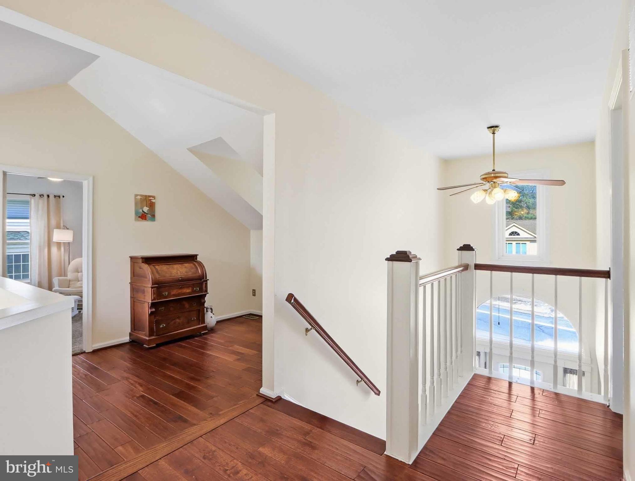 12208 Stoney Bottom Road Germantown, MD 20874 - Photo 23 of 52 a view of a hallway with wooden floor and staircase
