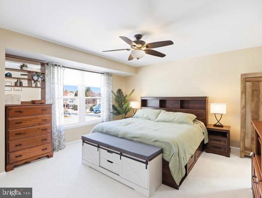 12208 Stoney Bottom Road Germantown, MD 20874 - Photo 25 of 52 a spacious bedroom with a bed and a dresser