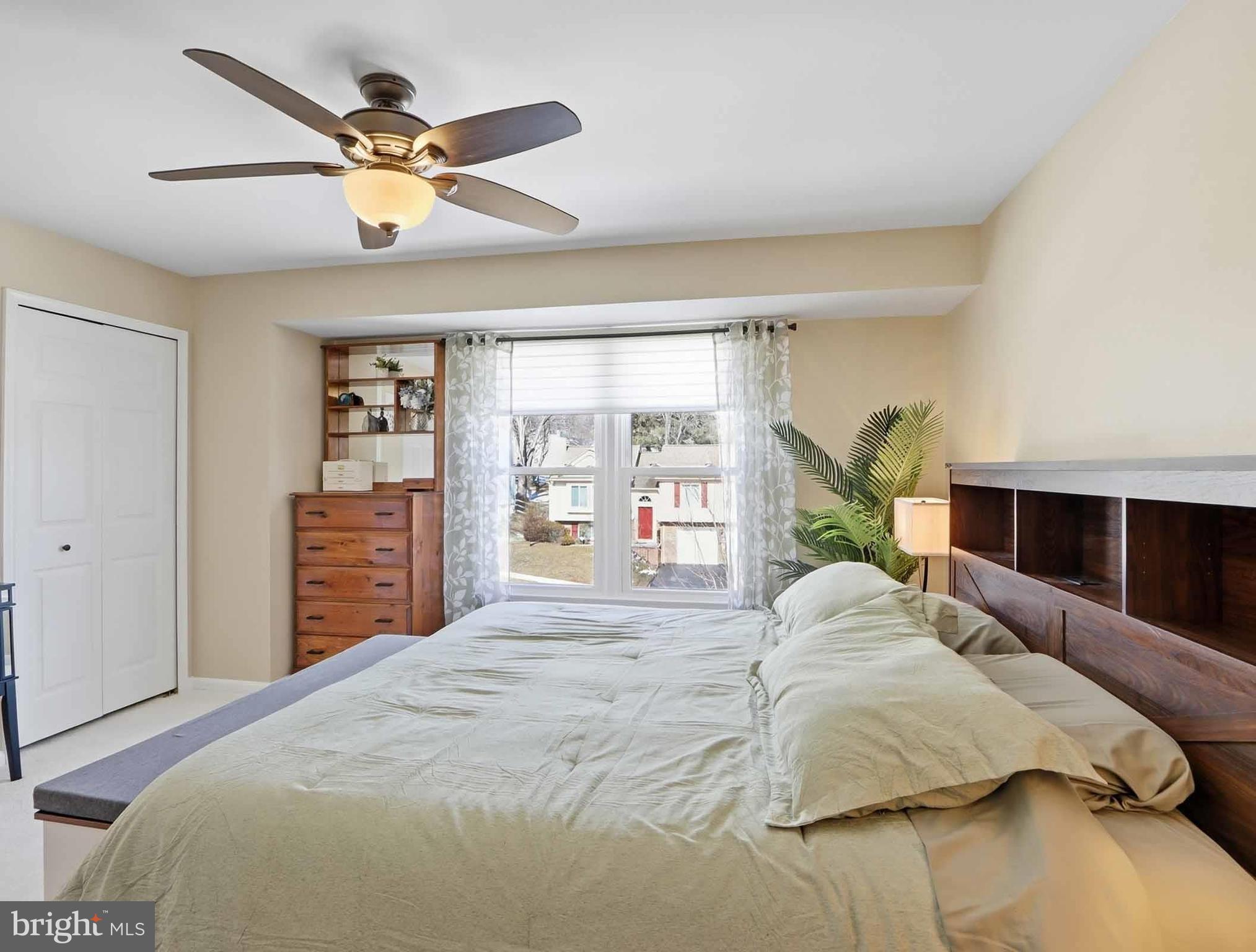 12208 Stoney Bottom Road Germantown, MD 20874 - Photo 27 of 52 a spacious bedroom with a bed a dresser and a large window