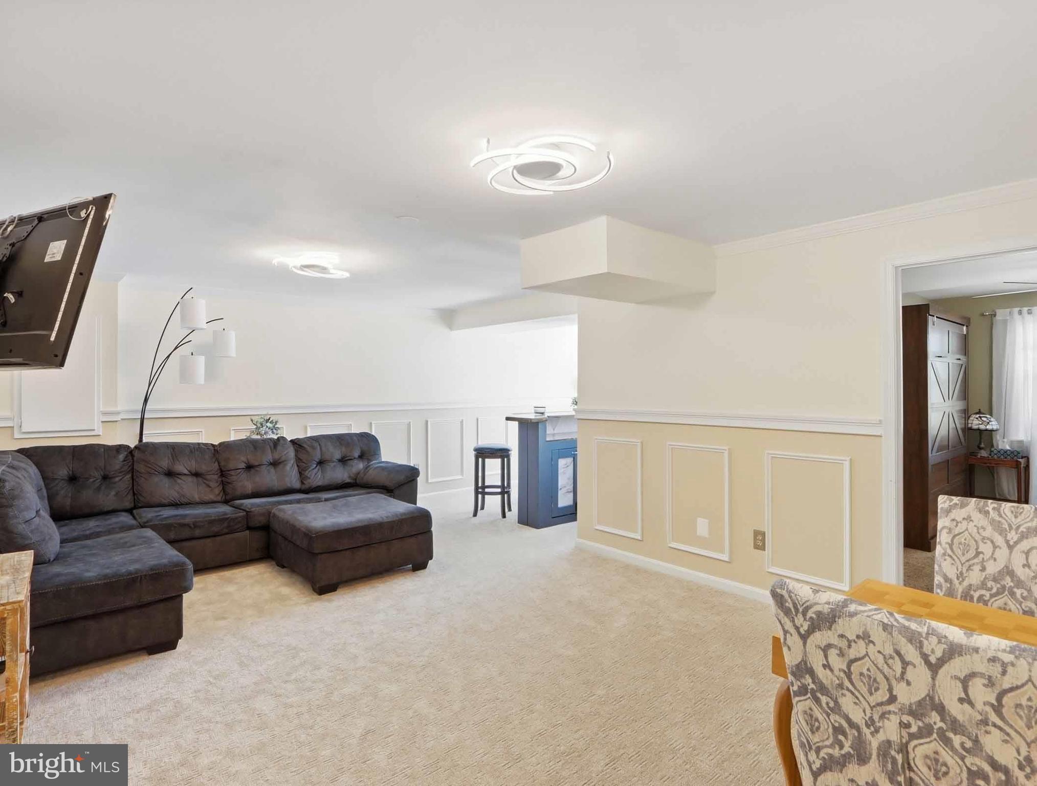 12208 Stoney Bottom Road Germantown, MD 20874 - Photo 35 of 52 a living room with furniture and a couch