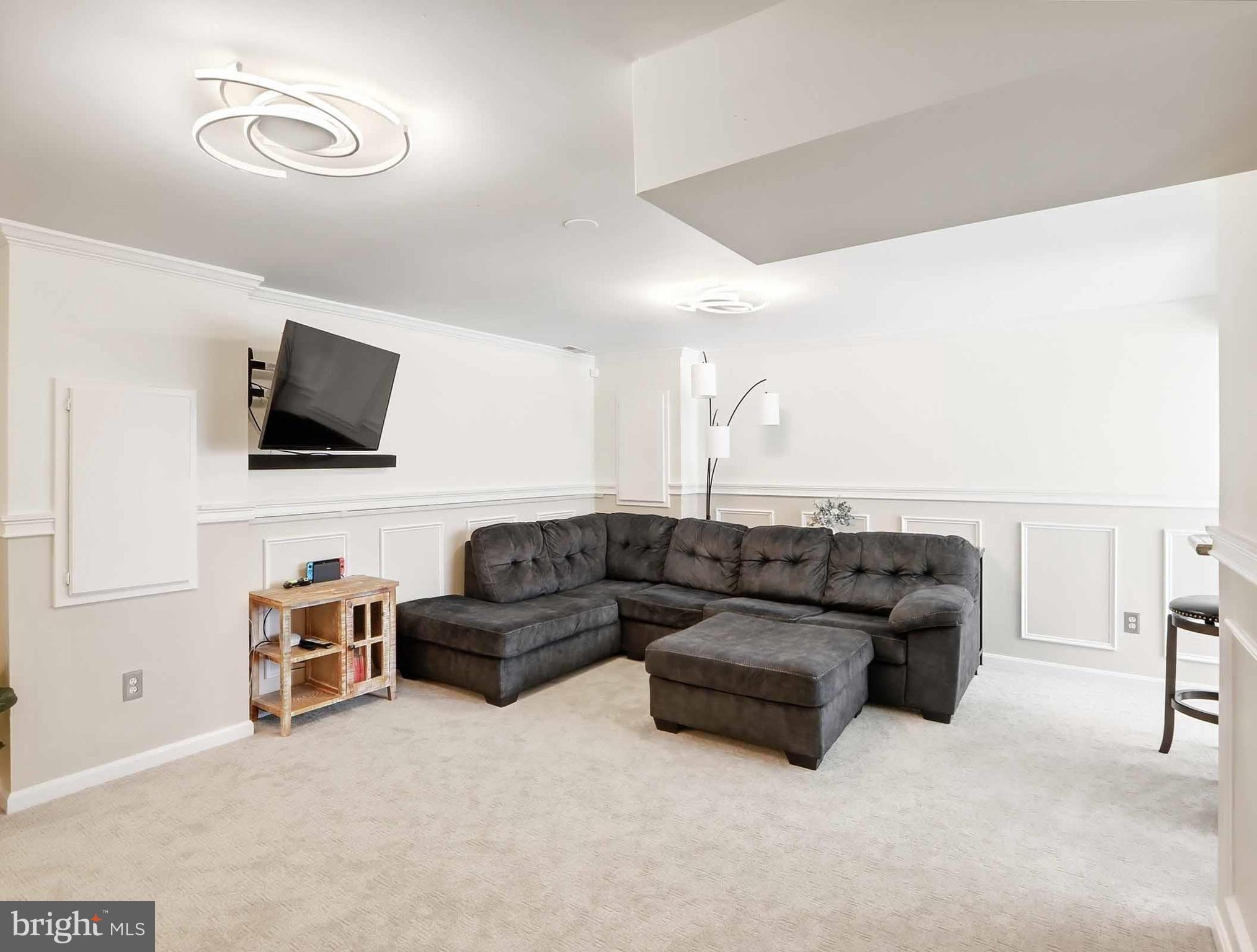 12208 Stoney Bottom Road Germantown, MD 20874 - Photo 36 of 52 a living room with furniture and a flat screen tv