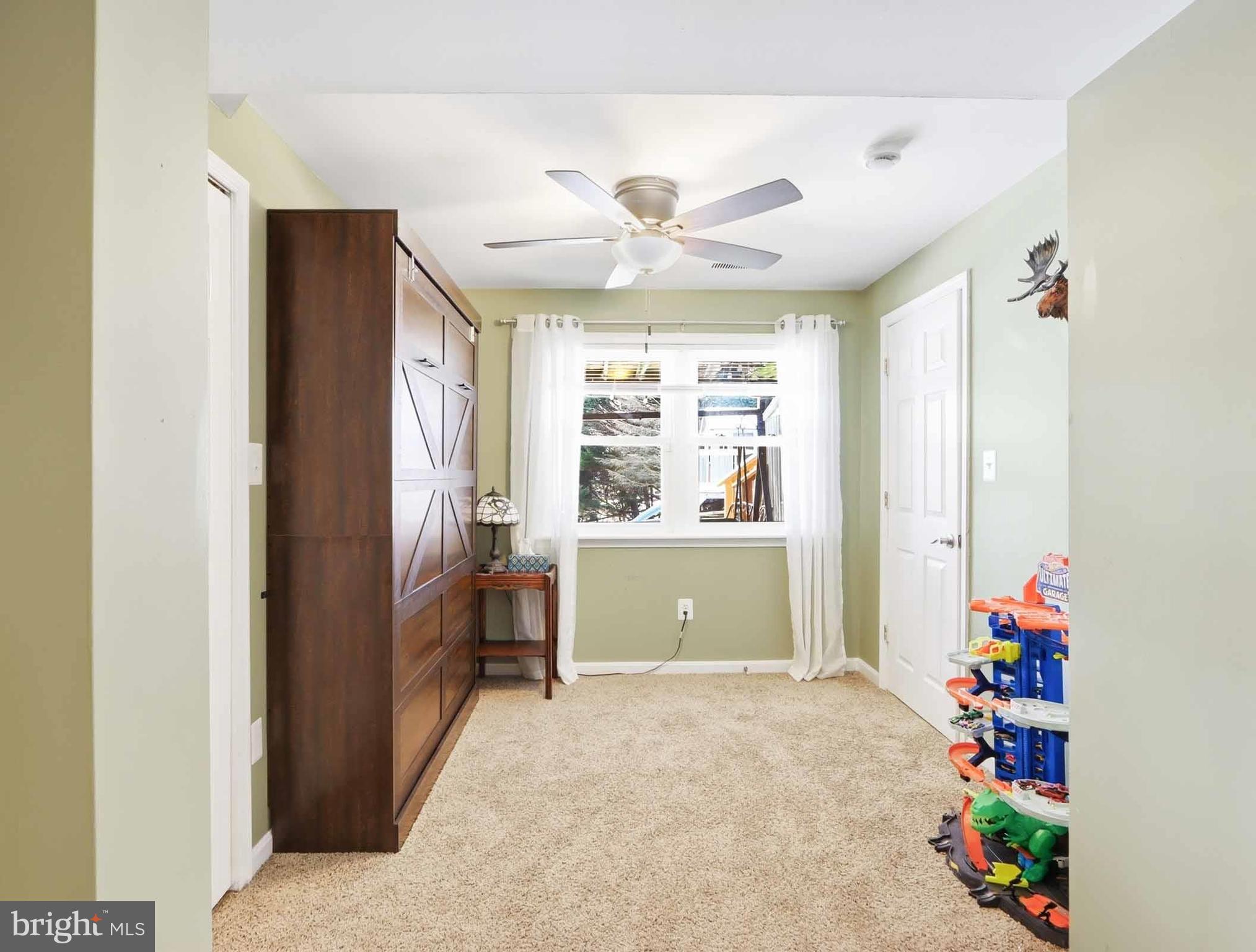 12208 Stoney Bottom Road Germantown, MD 20874 - Photo 39 of 52 a living room with furniture and a window