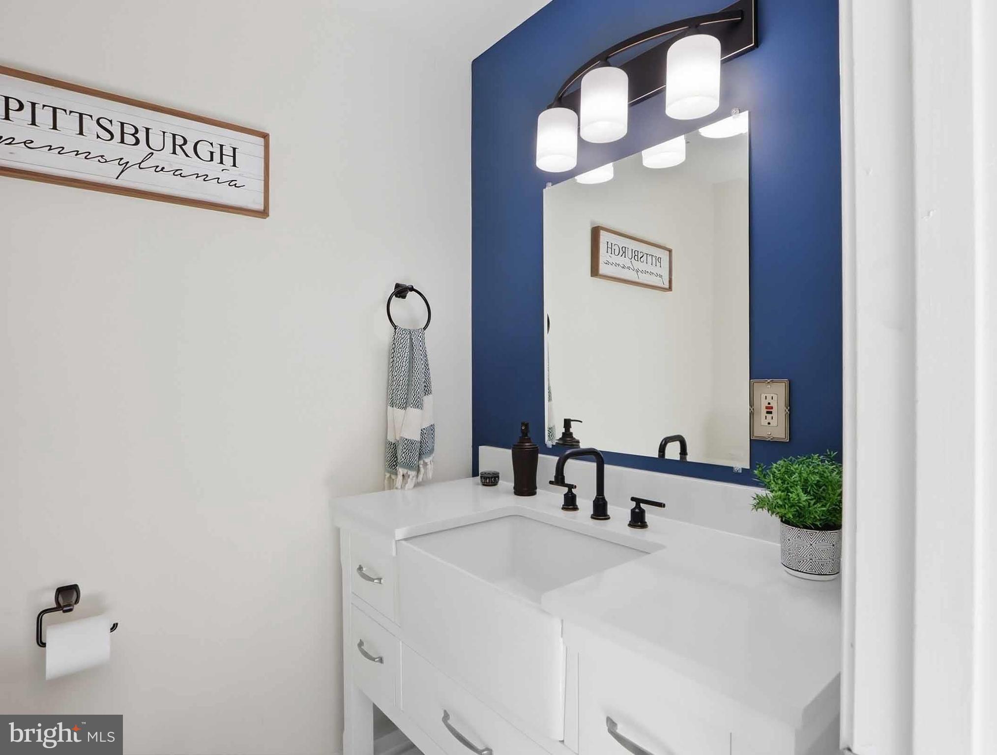 12208 Stoney Bottom Road Germantown, MD 20874 - Photo 42 of 52 a bathroom with a sink and a mirror